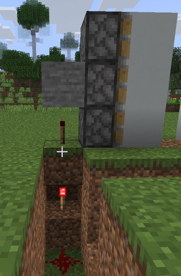 Completing the underground redstone wiring for an automatic piston door in Minecraft.