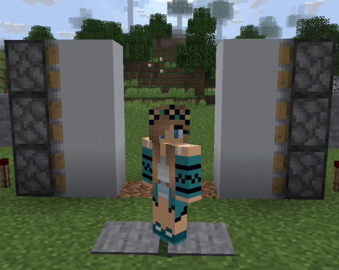 A Minecraft player character standing in front of their newly built, open 2x2 redstone piston door.