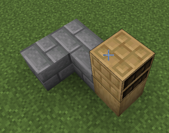 The starting blocks for a secret bookshelf door in Minecraft, showing the corner of a wall with a bookshelf placed.